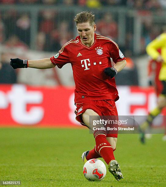 Bastian Schweinsteiger of Muenchen runs with the ball during the DFB Cup Quarter Final match between FC Bayern Muenchen and Borussia Dortmund at...