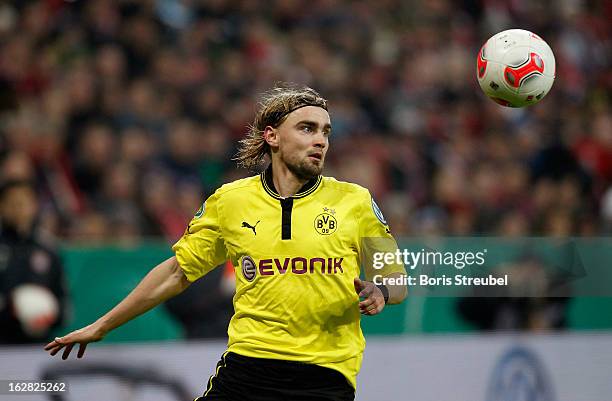 Marcel Schmelzer of Dortmund runs with the ball the DFB Cup Quarter Final match between FC Bayern Muenchen and Borussia Dortmund at Allianz Arena on...