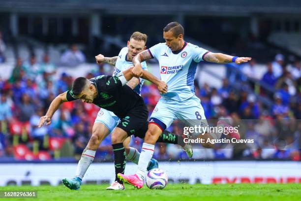 Juan Brunetta of Santos fights for the ball with Jesus Dueñas of Cruz Azul during the 4th round match between Cruz Azul and Santos Laguna as part of...