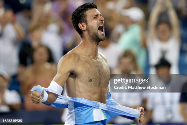 Novak Djokovic of Serbia tears his shirt off after defeating Carlos Alcaraz of Spain during the final of the Western & Southern Open at Lindner...