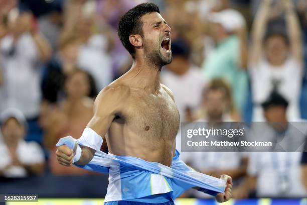 Novak Djokovic of Serbia tears his shirt off after defeating Carlos Alcaraz of Spain during the final of the Western & Southern Open at Lindner...