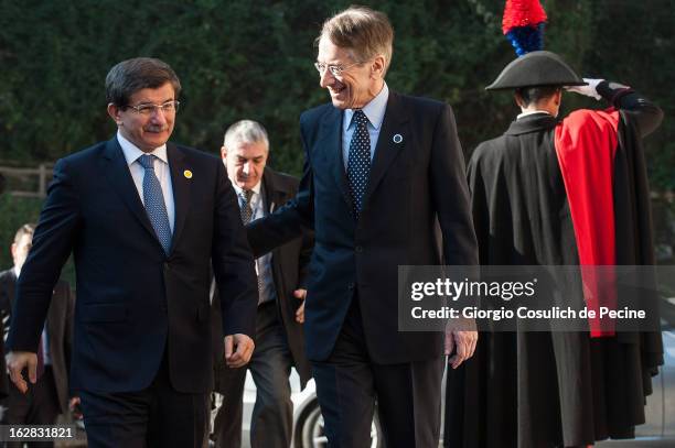Turkey's Foreign Minister Ahmet Davutoglu meets with Italy's Foreign Minister Giulio Terzi as he arrives to attend a meeting of the 'Friends of the...