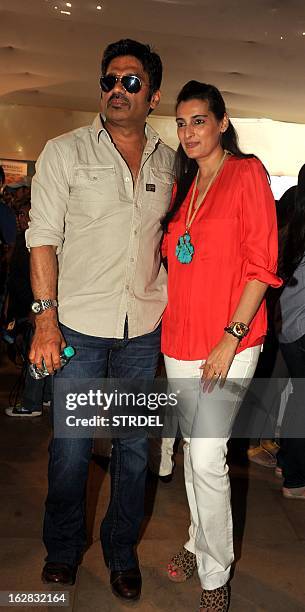 Indian Bollywood actor Suniel Shetty poses for a photo with his wife Mana Shetty , who organised an exhibition by the Save The Children Foundation in...