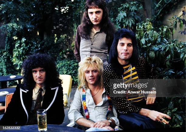Brian May, John Deacon , Roger Taylor and Freddie Mercury of British rock group Queen at Les Ambassadeurs where they were presented with silver, gold...