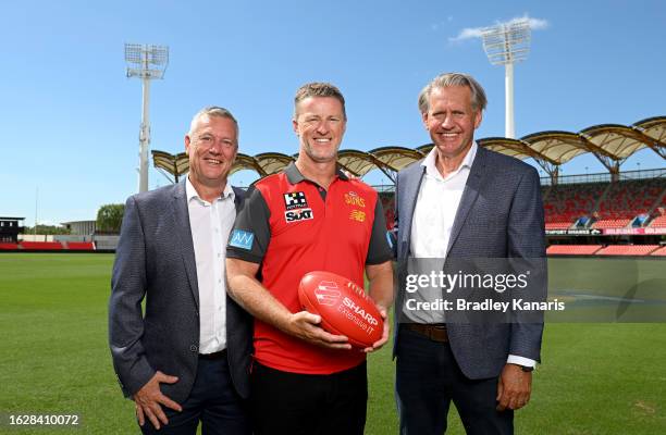 Damien Hardwick poses for a photo with Chief Executive Mark Evans and Chairman Bob East after a Gold Coast Suns AFL press conference announcing the...