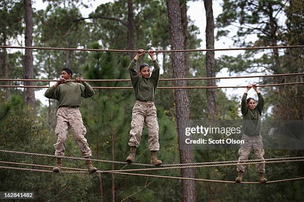 Female Marine recruits navigate an obstacle on the Confidence Course during boot camp February 27, 2013 at MCRD Parris Island, South Carolina. Female...