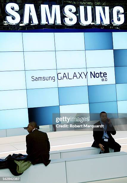 Visitors wait for the next product demonstration at the Samsung stand on February 28, 2013 in Barcelona, Spain. The annual Mobile World Congress...