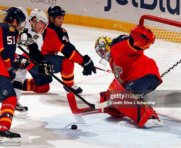 Goaltender Scott Clemmensen of the Florida Panthers defends the net against Brooks Orpik of the Pittsburgh Penguins at the BB&T Center on February...