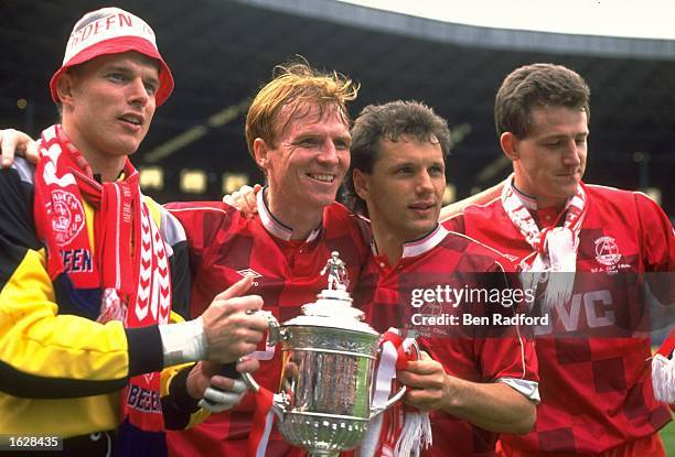 Theo Snelders , McLeish ,Gillhaus and Brian Irvine all of Aberdeen celebrate with the trophy after their victory in the Scottish Cup Final against...