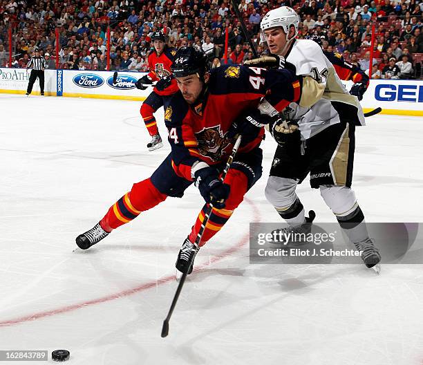 Erik Gudbranson of the Florida Panthers skates for possession against Chris Kunitz of the Pittsburgh Penguins at the BB&T Center on February 26, 2013...
