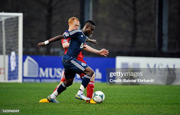 Gershon Koffie of the Vancouver Whitecaps FC and Jeff Larentowicz of the Chicago Fire battle for the ball during the first half of the Carolina...