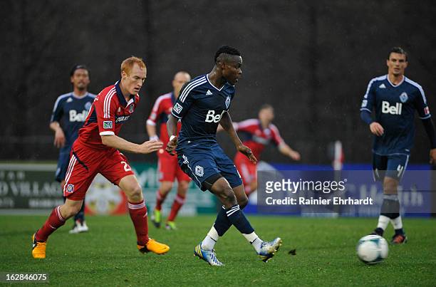 Gershon Koffie of the Vancouver Whitecaps FC and Jeff Larentowicz of the Chicago Fire battle for the ball during the first half of the Carolina...