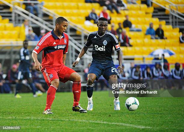 Sherjill MacDonald of the Chicago Fire and Gershon Koffie of the Vancouver Whitecaps FC battle for the ball during the first half of the Carolina...