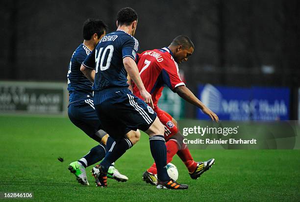 Sherjill MacDonald of the Chicago Fire battles for the ball against Young-Pyo Lee of the Vancouver Whitecaps FC and teammate Andy O'Brien during the...