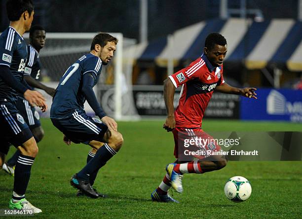 Yazid Atouba of the Chicago Fire dribbles the ball past Jun-Marques Davidson of the Vancouver Whitecaps FC during the second half of the Carolina...