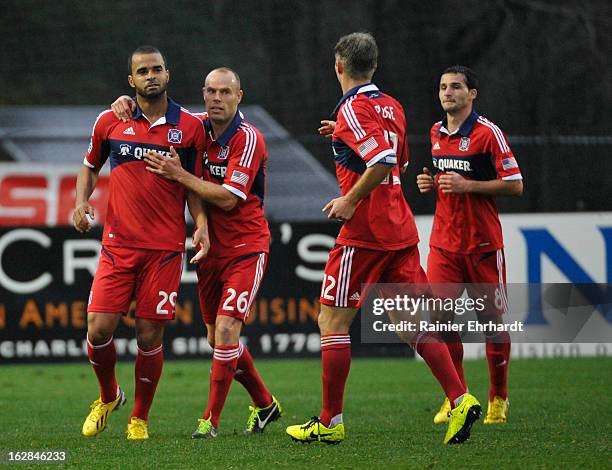 Maicon Santos of the Chicago Fire celebrates with teammate Joel Lindpere and other members of his team after scoring a goal during the second half of...
