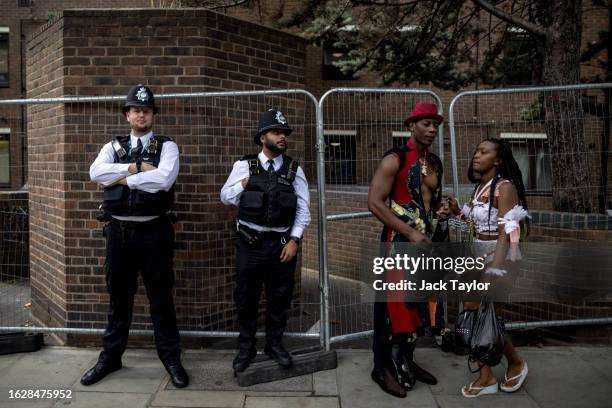 Police officers and revellers look on during the final day of Notting Hill Carnival on August 28, 2023 in London, England. The annual Caribbean...