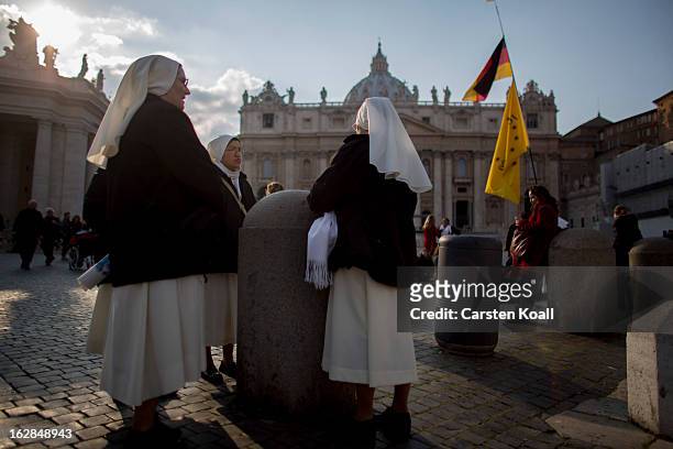 Nuns gather before they follow the livestreaming online coverage of Pope Benedict XVI's depature to Castel Gandolfo on a screen in St Peter's Square...