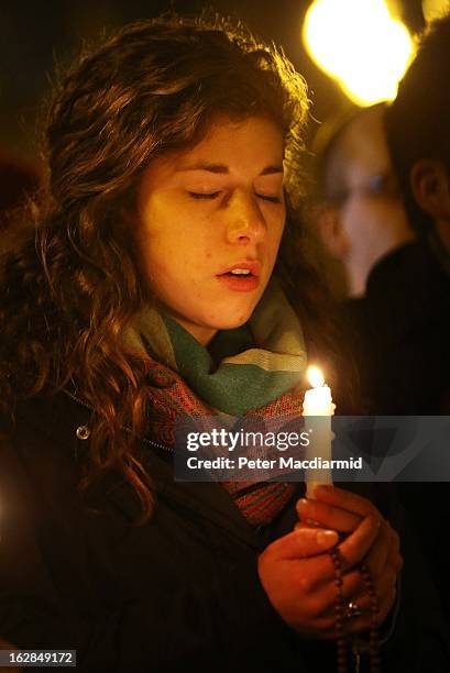 Girl stands with a candle in St Peter's Square as prayers are said for Pope Benedict XVI in the moments before he ceased to be Pontiff at 20:00 CET...