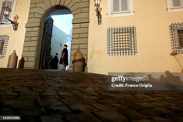 Swiss Guards prepare to close the gate of the Apostolic Palace after Pope Benedict XVI greeted the pilgrims, for the last time as head of the...