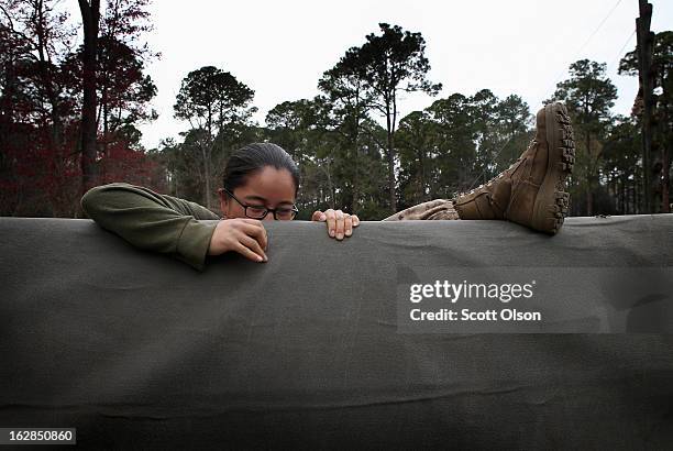 Marine recruit Gaoshia Xiong of Ozark, Arkansas struggles to climb an obstacle on the Confidence Course during boot camp February 27, 2013 at MCRD...