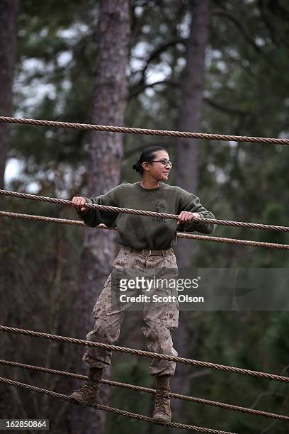 Marine recruit Reyna Cazares of Dallas, Texas navigates an obstacle on the Confidence Course during boot camp February 27, 2013 at MCRD Parris...