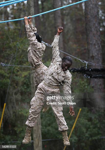 Marine recruit loses her grip and falls while trying to navigate an obstacle on the Confidence Course during boot camp February 27, 2013 at MCRD...