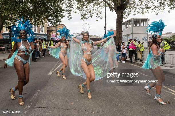 Samba performers in colourful costumes dance to the rhythms of the mobile sound systems during the grand finale of the Notting Hill Carnival in...
