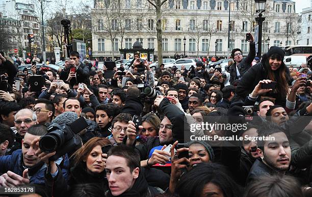 Fans crowd around as they try their best to catch a glimpse of David Beckham as he attends an autograph session at adidas Performance Store...