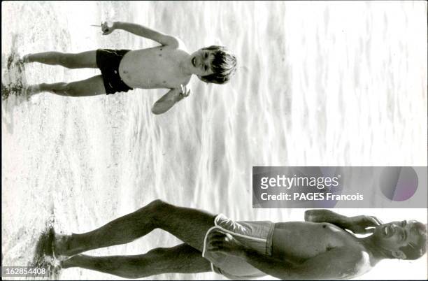 Rendezvous With Roger Vadim On Holiday In Saint-Tropez. Ramatuelle - Juin 1966 --- Roger VADIM se baigne sur la plage du Club 55 avec son fils...