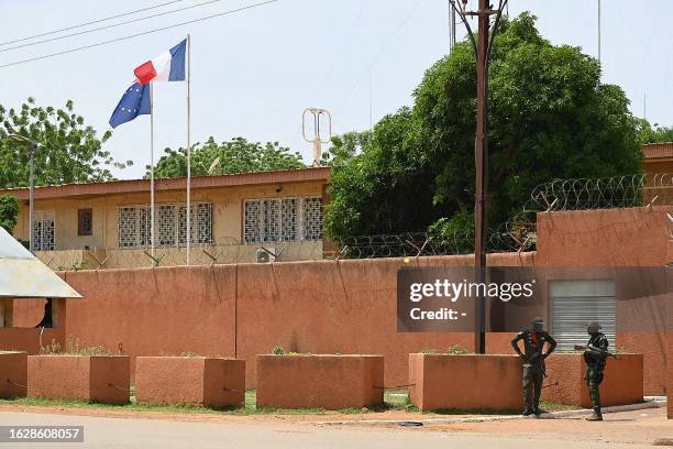 Officers of the Niger national Police are seen outside the French Embassy in Niamey on August 28, 2023. Thousands of people demonstrated on August...