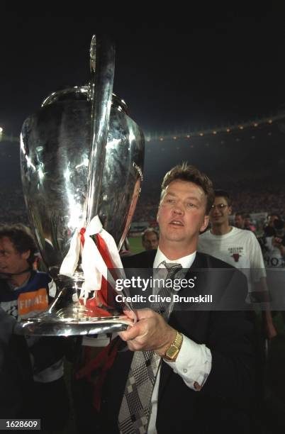 Louis Van Gaal the Ajax Coach raises the trophy in celebration after their victory in the European Cup Final against AC Milan in Vienna, Austria....