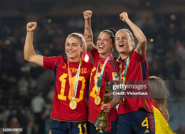 Alexia Putellas, Jennifer Hermoso and Irene Paredes of Spain celebrate with the winners' trophy after the FIFA Women's World Cup Australia & New...