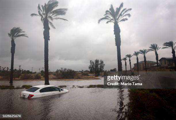 Car is partially submerged in floodwaters as Tropical Storm Hilary moves through the area on August 20, 2023 in Cathedral City, California. Southern...