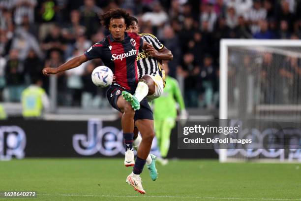 Alex Sandro of Juventus Fc and Joshua Zirkzee of Bologna Fc battle for the ball during the Serie A TIM match between Juventus and Bologna FC at...