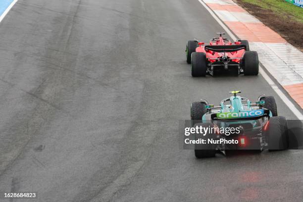 Rear view of Charles Leclerc of Monaco driving the car no 16, a Ferrari SF-23 followed by Fernando Alonso of Spain driving the car number 14 of Aston...