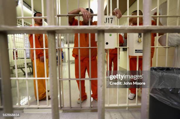 Immigration detainees stand behind bars at the Immigration and Customs Enforcement , detention facility on February 28, 2013 in Florence, Arizona....