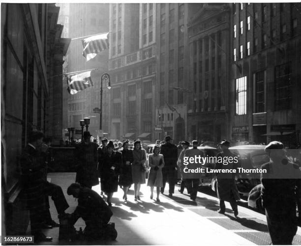 Crowds walking down Broad Street in New York City, 1955.