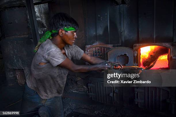 Worker prepares a burner for processing and colour-dyeing at a dyeing factory on April 6, 2009 in Rajasthan, India.