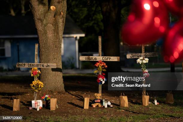 Morning sun shines on memorials for Jerrald Gallion, Angela Carr and Anolt Joseph Laguerre Jr. Near a Dollar General store where they were shot and...