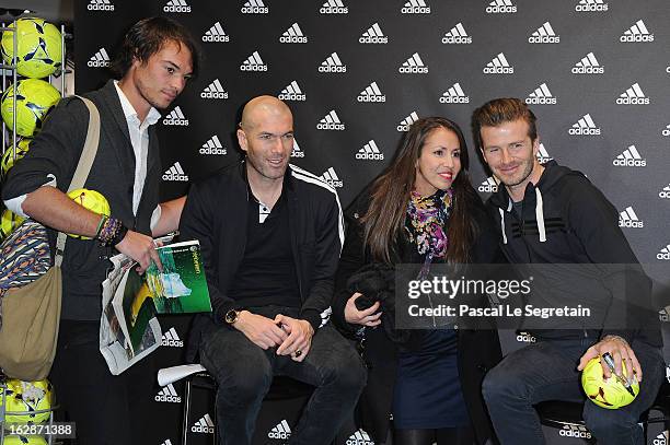 David Beckham and Zinedine Zidane pose with fans as they attend an autograph session at adidas Performance Store Champs-Elysees on February 28, 2013...