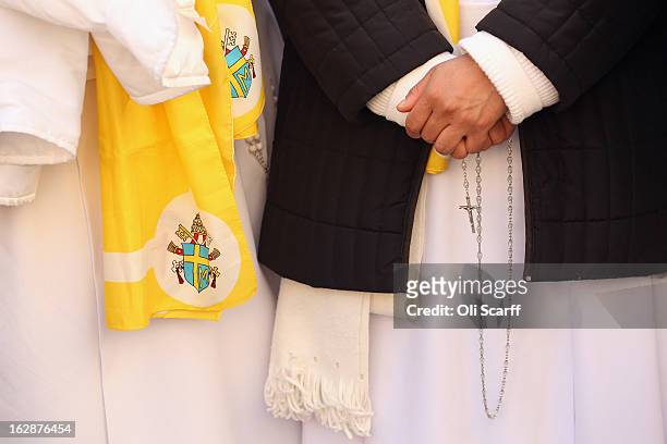 Nuns wait for Pope Benedict XVI to wave to pilgrims, for the last time as head of the Catholic Church, from the window of Castel Gandolfo where he...