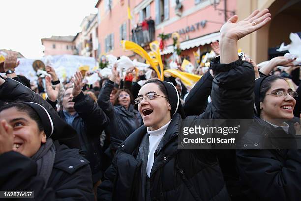 Nuns cheer as Pope Benedict XVI waves to pilgrims, for the last time as head of the Catholic Church, from the window of Castel Gandolfo where he will...