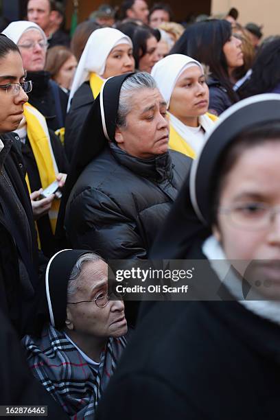 Nuns wait for Pope Benedict XVI to wave to pilgrims, for the last time as head of the Catholic Church, from the window of Castel Gandolfo where he...