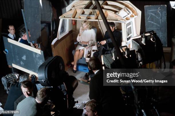 Elevated view of the cast and crew on set during the filming of 'Modesty Blaise' , 1965. Italian actress Monica Vitti and English actor Terence Stamp...