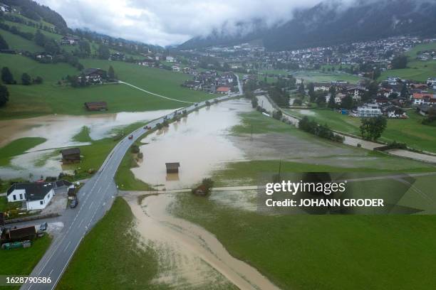 This aerial view shows flooded fields and pathways along the river Ruetz in Neustift im Stubaital, Tirol, western Austria, on August 28, 2023....