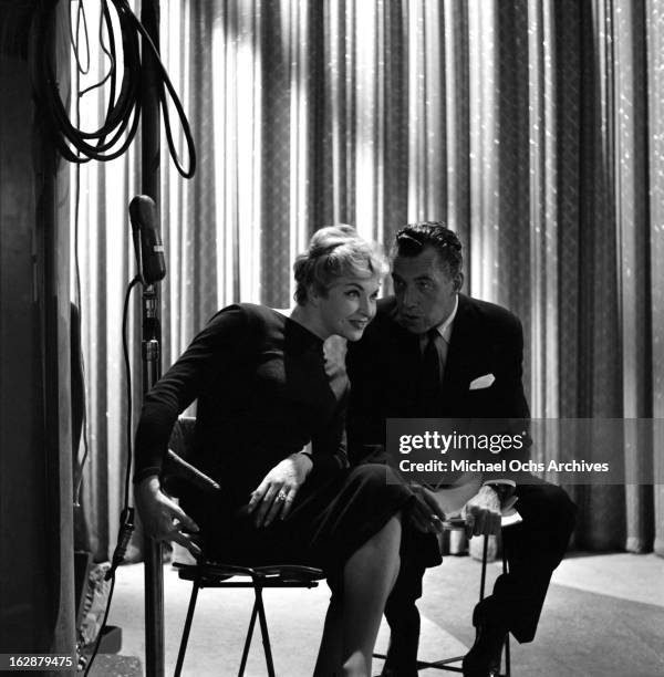 French singer and actress Line Renaud chats with Ed Sullivan backstage on The Ed Sullivan Show on October 12, 1958 in New York City, New York.