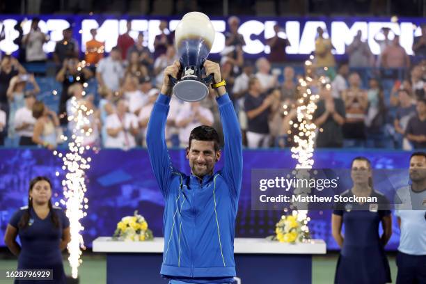 Novak Djokovic of Serbia celebrates with the trophy after defeating Carlos Alcaraz of Spain during the final of the Western & Southern Open at...