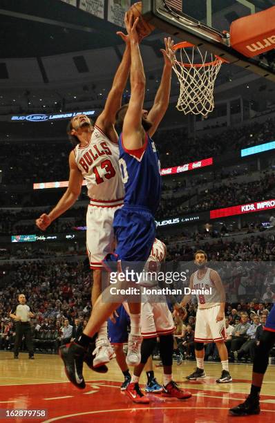 Joakim Noah of the Chicago Bulls blocks a shot by Spencer Hawes of the Phildelphia 76ers at the United Center on February 28, 2013 in Chicago,...