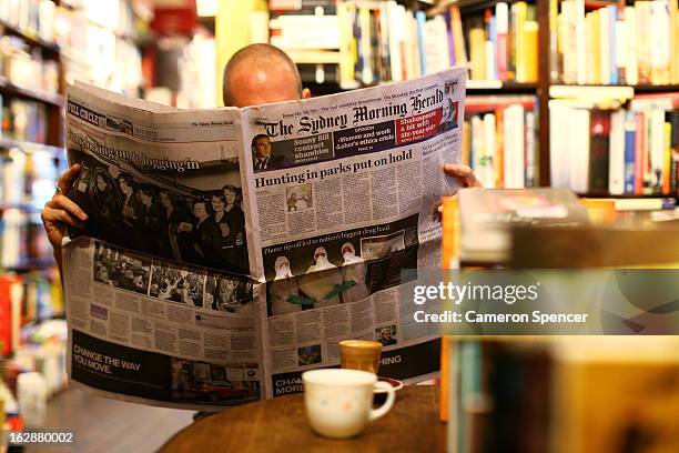 Man reads the broadsheet format 'Sydney Morning Herald' newspaper at a cafe on March 1, 2013 in Sydney, Australia. After 180 years, the Monday to...
